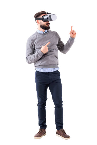 istock Smart casual businessman wearing vr glasses pointing finger up at copyspace 931172228
