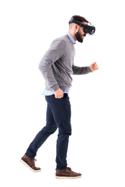 istock Side view of bearded man watching virtual reality glasses running and looking down 931172972