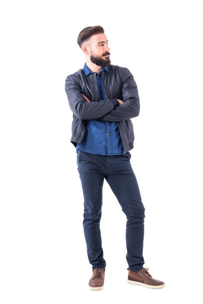istock Confident young bearded man in bomber jacket with crossed arms looking away. 931173388