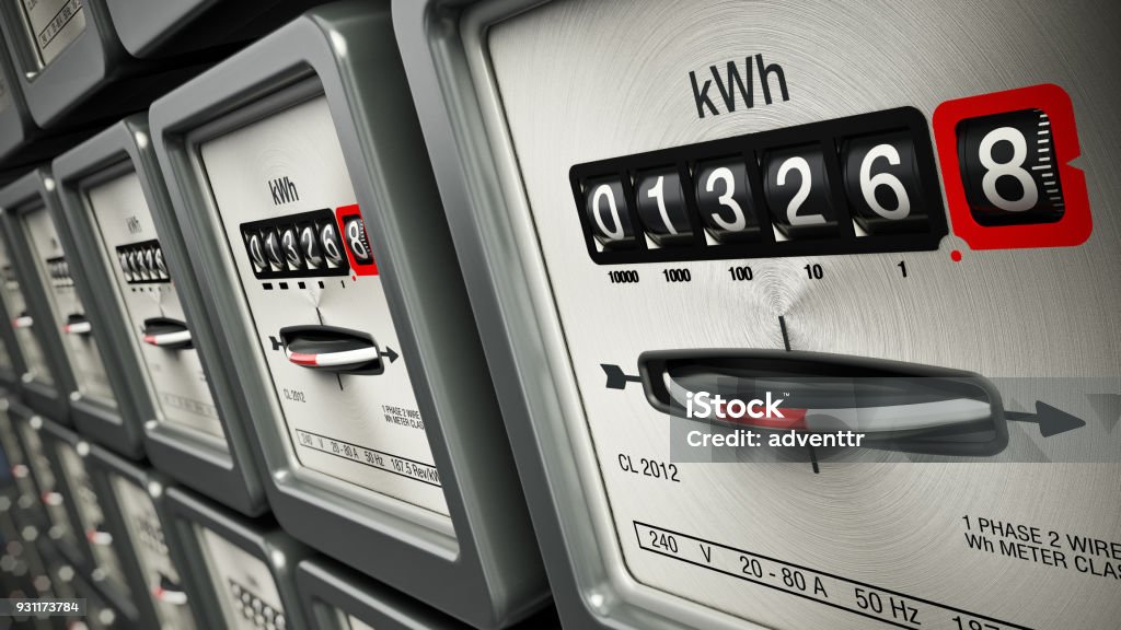 Electric meters in a row standing on the wall Electric meters in a row standing on the wall. Electricity Stock Photo