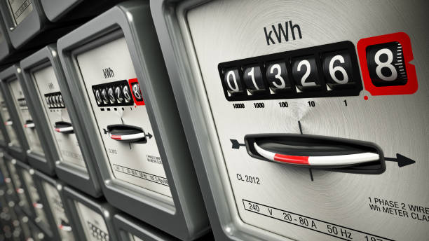 Electric meters in a row standing on the wall stock photo