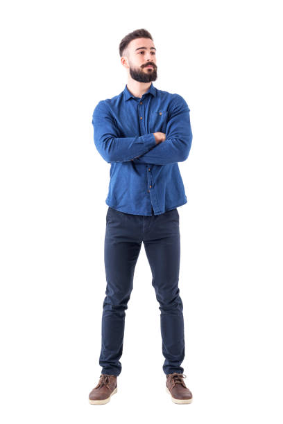 istock Confident cool young bearded man standing and looking away with crossed hands 931173894