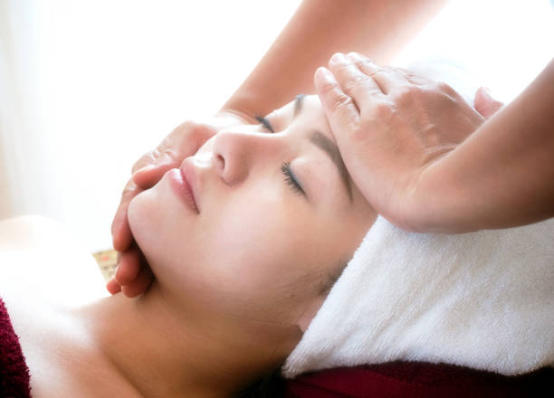 istock young woman getting spa face massage at beauty salon. 931174114