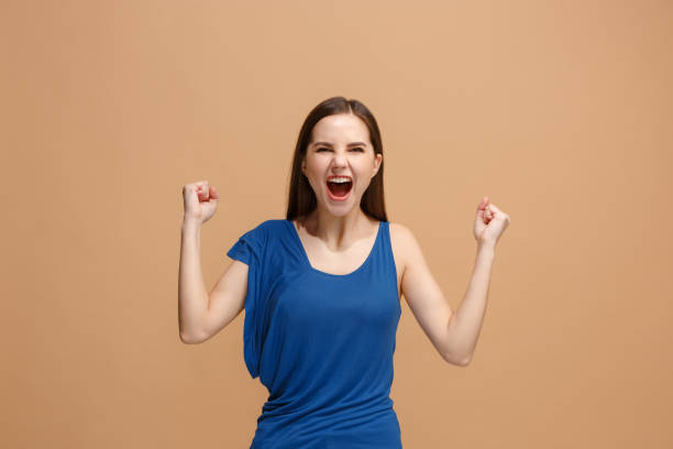 istock Winning success woman happy ecstatic celebrating being a winner. Dynamic energetic image of female model 931178566