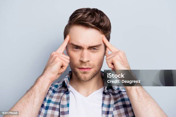 Close Up Portrait Of Attractive Concentrated Guy Thinking About Something Holding Fingers On Temple Trying To Find A Solution Ideas Having Bad Memory Headache Standing Over Grey Background Stock Photo - Download Image Now