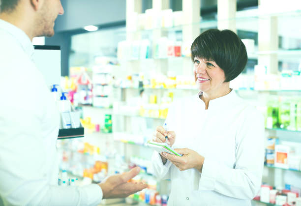 istock Woman druggist wearing white coat 931179808