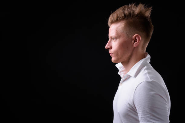 istock Handsome man with blond hair against black background 931189718