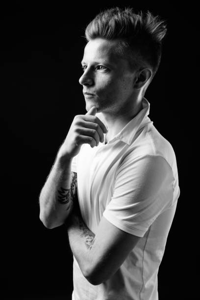 istock Handsome man against black background in black and white 931189780