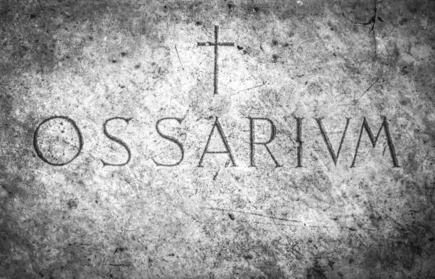 Ossuary cemetery with the engraving in Latin "Ossarium" (translation from Latin Ossario)