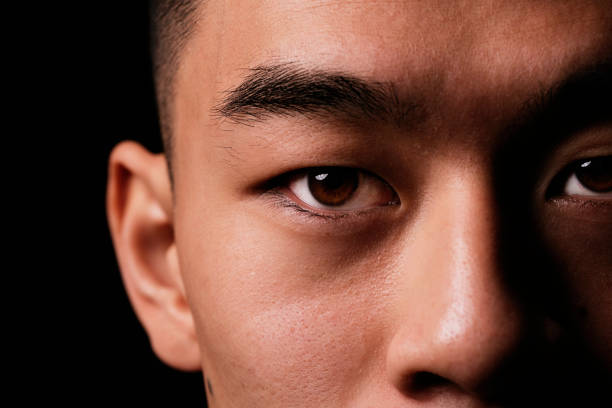 close detail of the eye of asian man. - human face chinese ethnicity close up men imagens e fotografias de stock