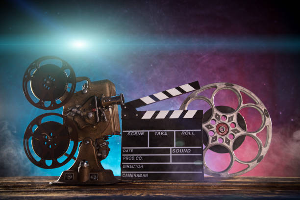istock Old style movie projector with clapperboard, close-up 931193690