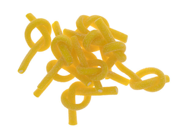 istock Sour lemon candy sticks in knots on a white background 931203686