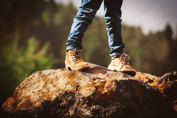 istock travel concept - little boy hiking boots in mountains 931209074
