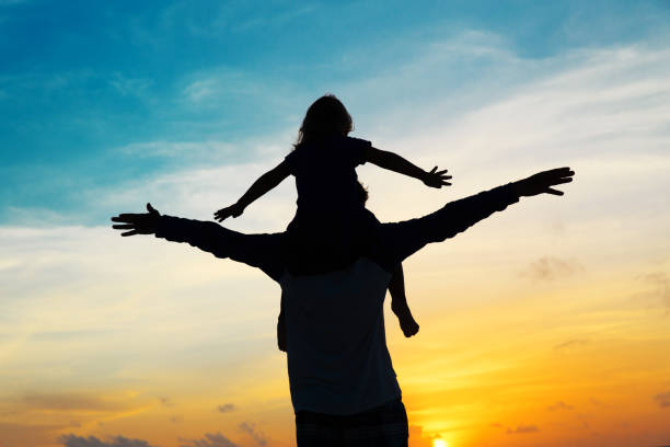 istock father and little daughter on shoulders play at sky 931209926