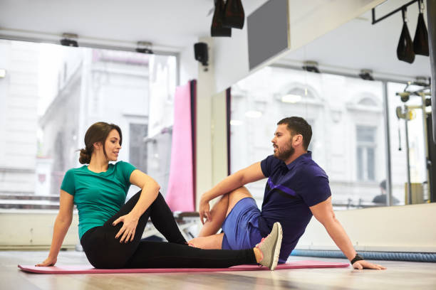 istock Woman with personal trainer. 931217434