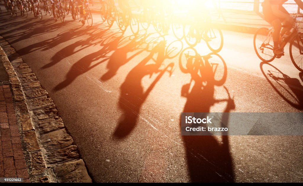 Shadows of bike riders at dawn Shadows of bicycle  riders at dawn Backgrounds Stock Photo