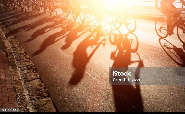 Shadows Of Bike Riders At Dawn Stock Photo - Download Image Now - Backgrounds, Sunrise - Dawn, Active Lifestyle