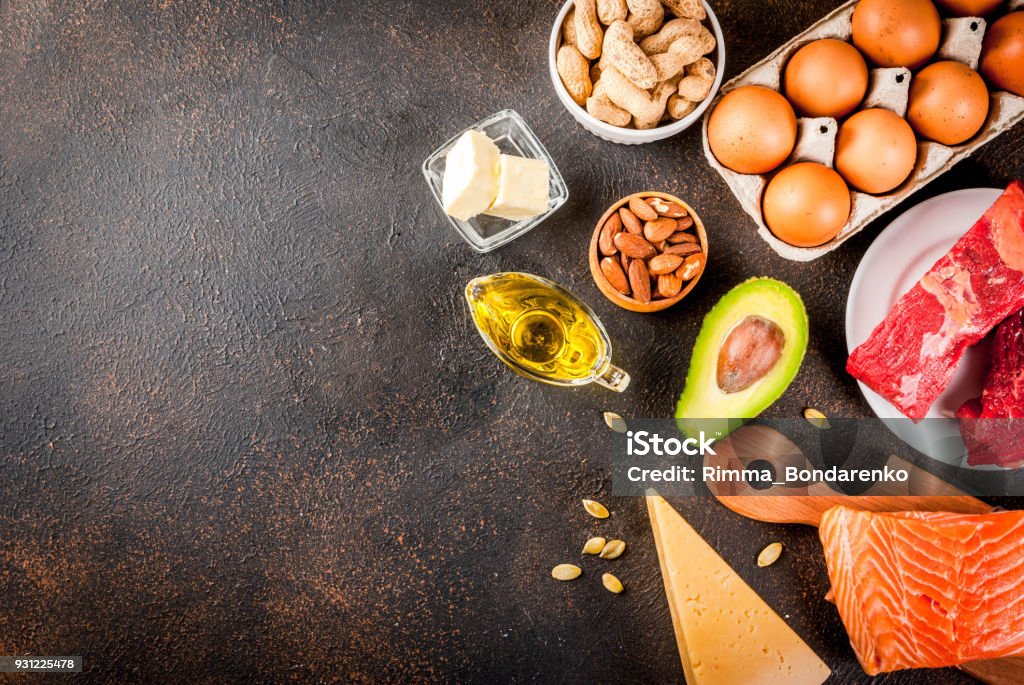 Ketogenic low carbs diet ingredients Ketogenic low carbs diet concept. Healthy balanced food with high content of healthy fats. Diet for the heart and blood vessels. Organic ingredients, dark rusty background, copy space top view Avocado Stock Photo