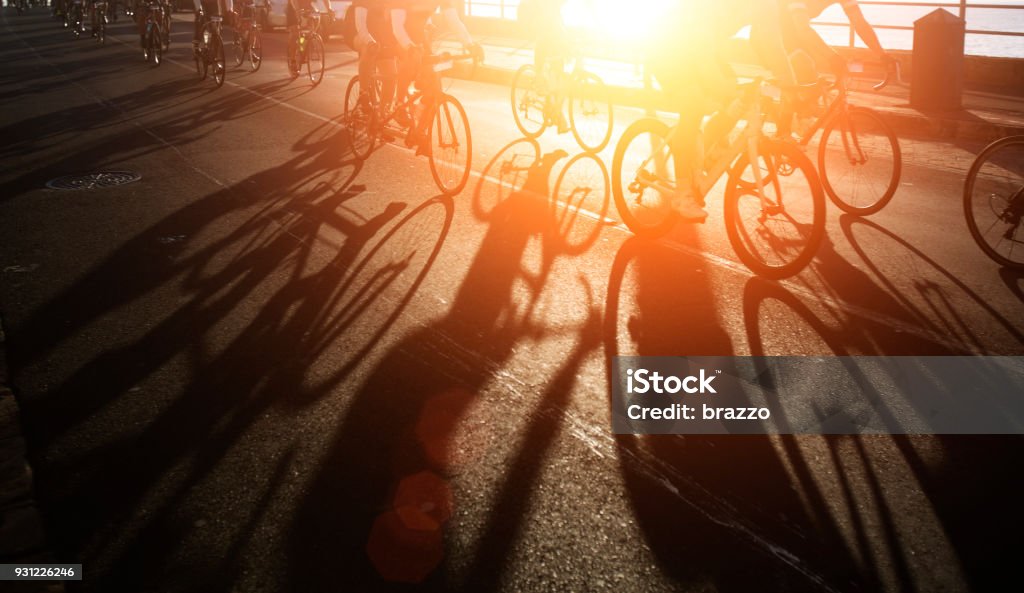 Shadows of bike riders at dawn Shadows of bicycle  riders at dawn Cycling Stock Photo