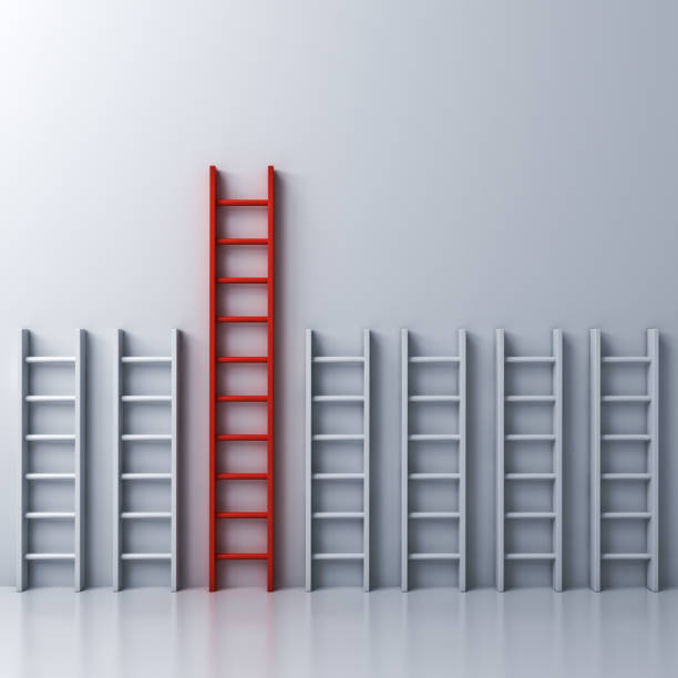 istock Longest red ladder among other short white ladders on white wall background 931227228