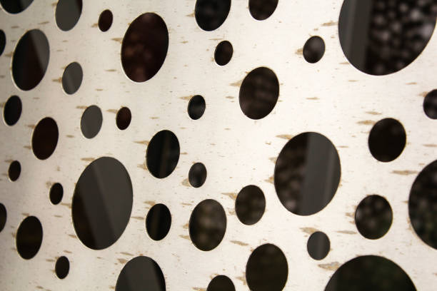 istock bright metal surface with round holes. abstract background 931227798