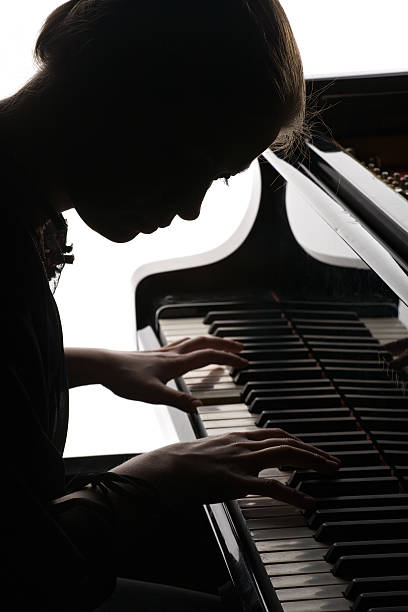 istock beautiful girl playing the piano 93122861