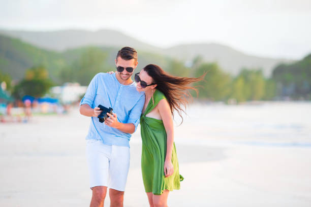 istock Young couple on beach vacation looking at camera 931231334