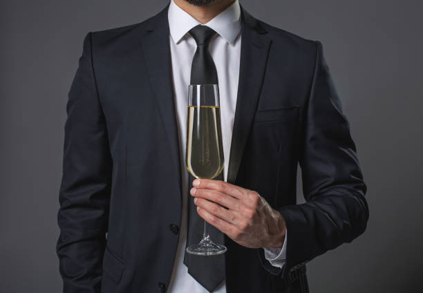 istock Standing young man with wineglass of champaghe 931231398