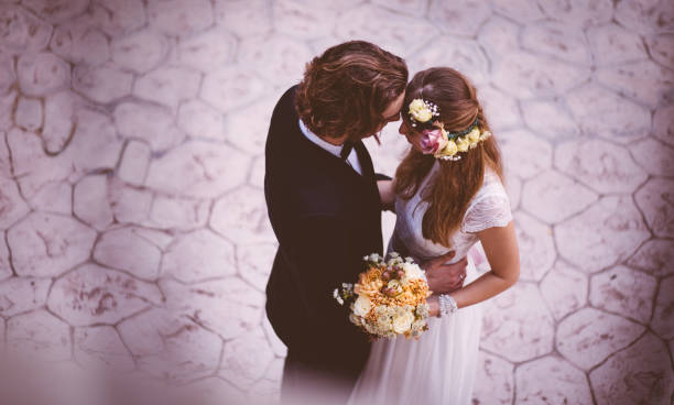 affectionate bride and groom embracing and dancing at wedding reception - fotos de boho imagens e fotografias de stock