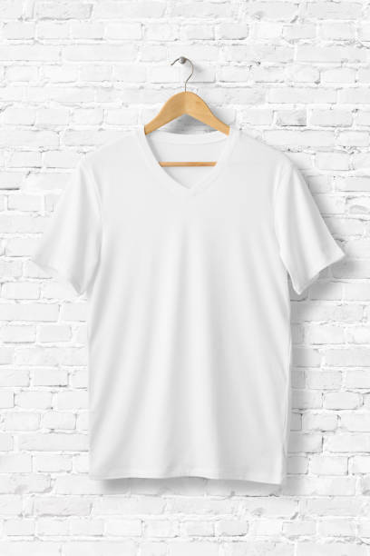 istock White V-Neck T-Shirts Mock-up hanging on white brick wall, front side view. 931234756