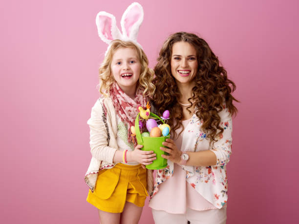 istock smiling modern mother and daughter showing Easter eggs bucket 931238998