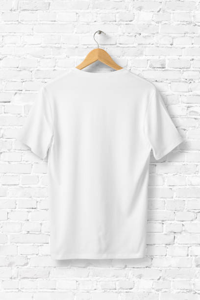 istock White V-Neck T-Shirts Mock-up hanging on white brick wall, rear side view. 931239324