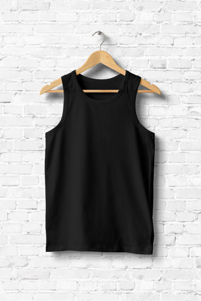 istock Black Tank Top Shirt Mock-up hanging on white brick wall, front view. 931240606