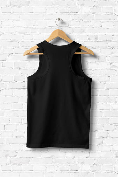 istock Black Tank Top Shirt Mock-up hanging on white brick wall, rear view. 931243080