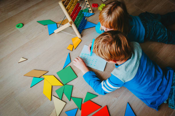 istock little boy and girl learn to write and calculate numbers 931244486