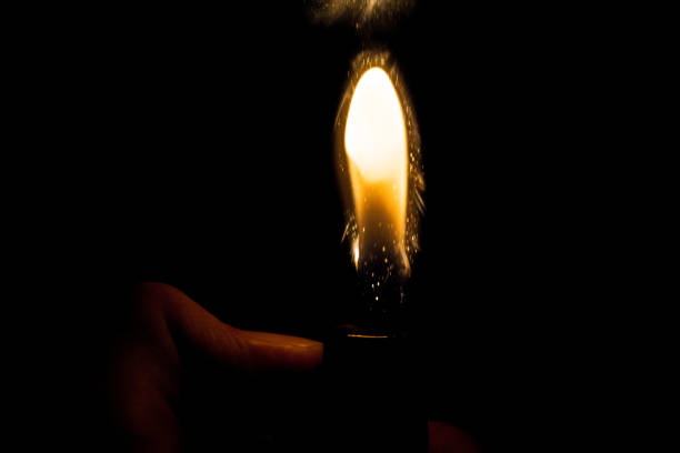 istock Close up view of real sparking light from lighter in dark black background 931245568