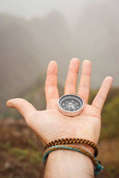 istock Hand with compass in the misty mountain terrain 931249398