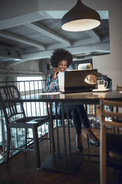 istock Young woman, African-American Ethnicity, working in cafe, using laptop 931249654
