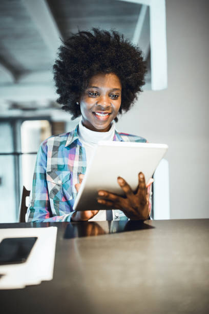 istock Young woman, African-American Ethnicity, working in cafe, using digital tablet. 931250074