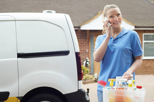 istock Young Woman Running Mobile Cleaning Business With Van Using Mobile Phone 931258056