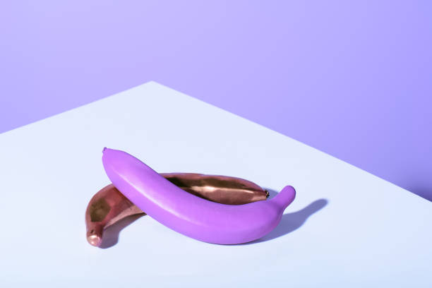 istock plastic purple and golden bananas on violet surface 931258152