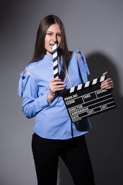 istock Young beautiful woman with movie cracker 931261756