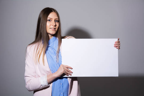 istock Young woman with blank sheet for advertising 931261794
