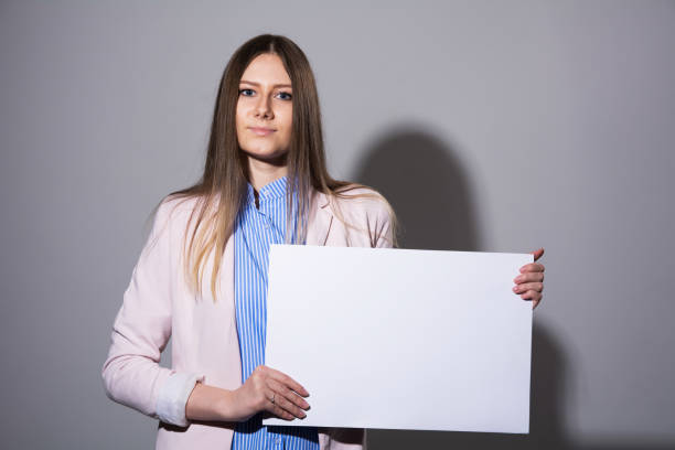 istock Young woman in a jacket with blank sheet 931261854