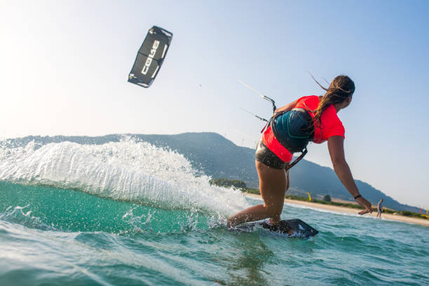 Woman doing kitesurfing Woman doing kitesurfing on sea and smiling. kite sailing stock pictures, royalty-free photos & images
