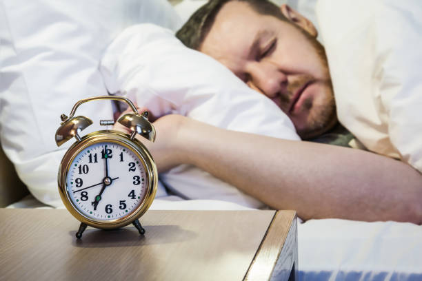 istock alarm clock stands on a bedside table in the room or hotel room 931267802