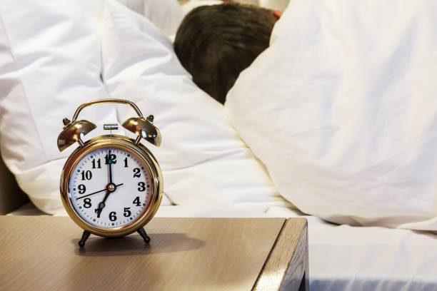 istock alarm clock stands on a bedside table in the room or hotel room 931269390