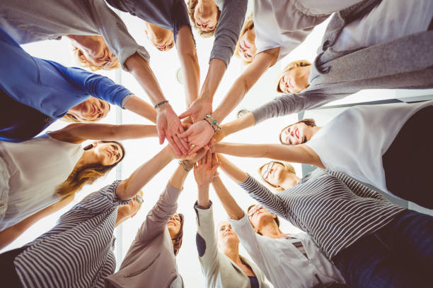 istock Group of women holding hands together 931270856