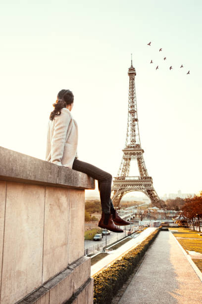 istock Woman looking at the Eiffel Tower in Paris 931274340