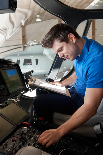 istock Male Aero Engineer With Clipboard Working In Helicopter Cockpit 931275100